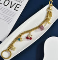 Gold Tone Purse Charm Chain with Dice, Cherry and Dinosaur Charms