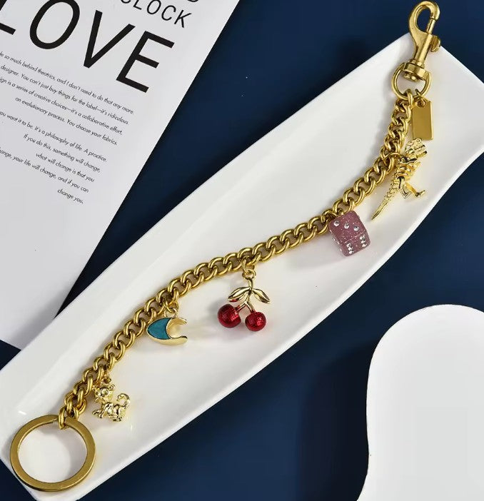 Gold Tone Purse Charm Chain with Dice, Cherry and Dinosaur Charms